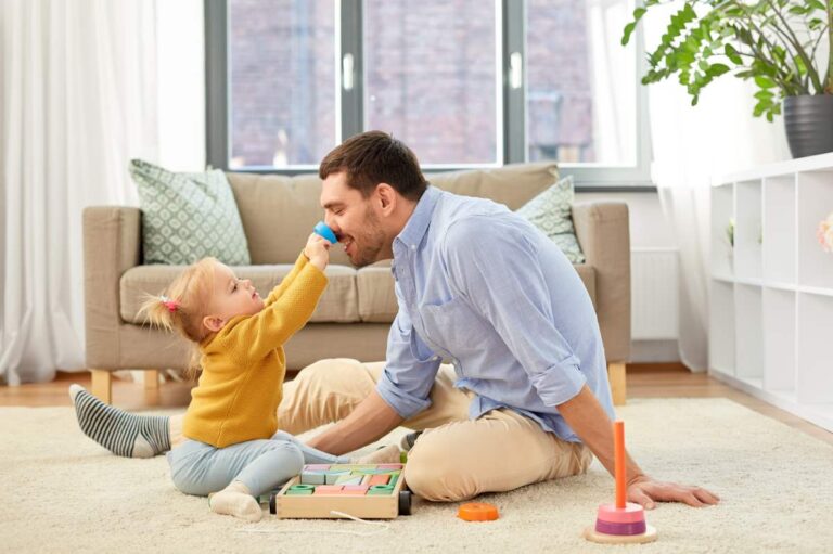 Daddy's playing with his daughter.