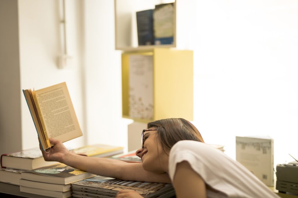 A girl is reading a book at home