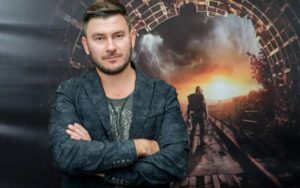 Dmitry Glukhovsky against the background of the "Metro 2033" artwork. Photo: Dmitry Sukhodolsky/Interpress/TASS