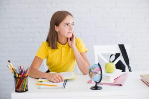 Thoughtful girl writes / Freepik