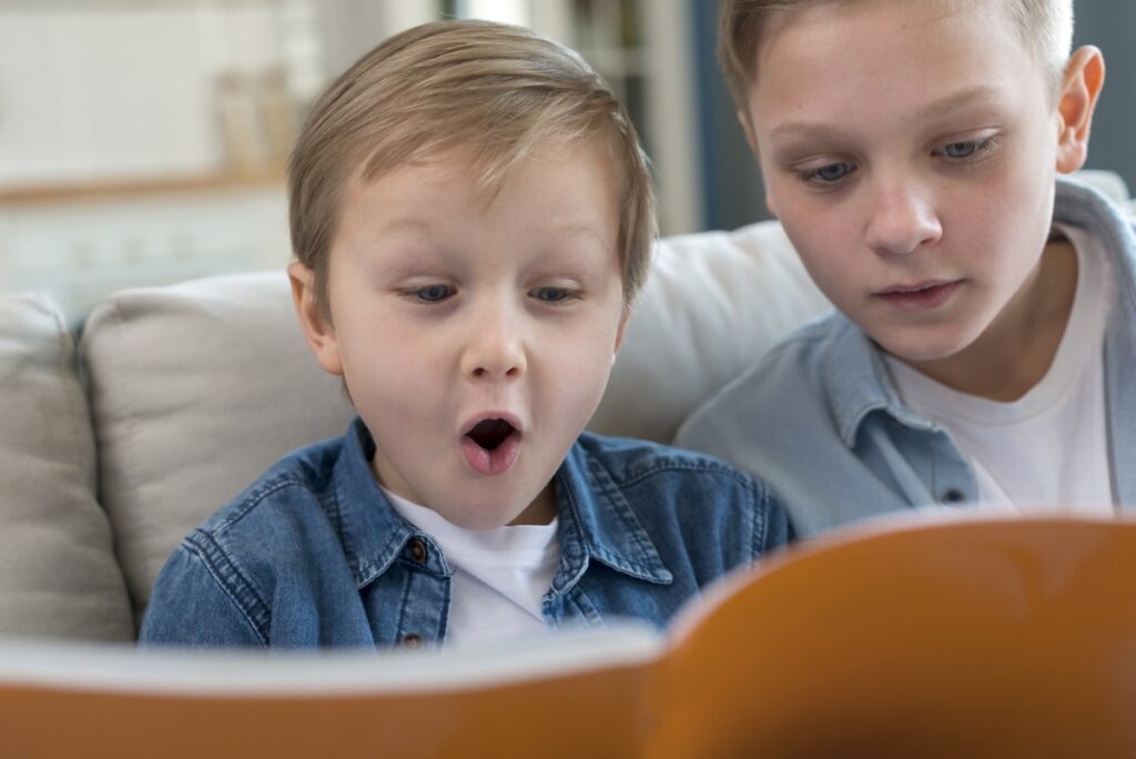 Two boys reading a book