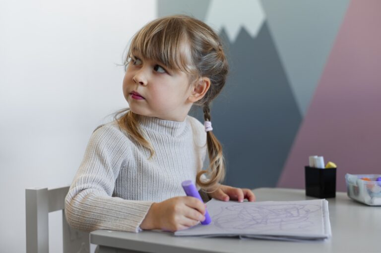 A girl sits at her desk and writes in her notebook