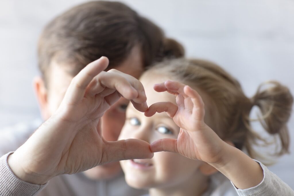Kids make a heart with their hands