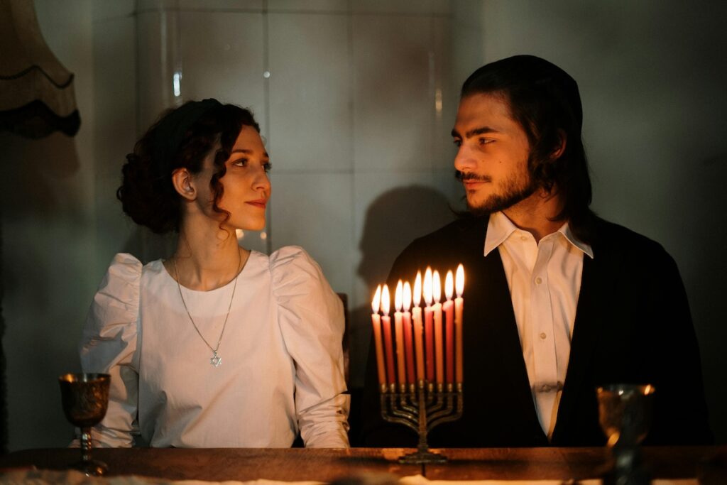 Hanukkah traditions - a guy and a girl with candles