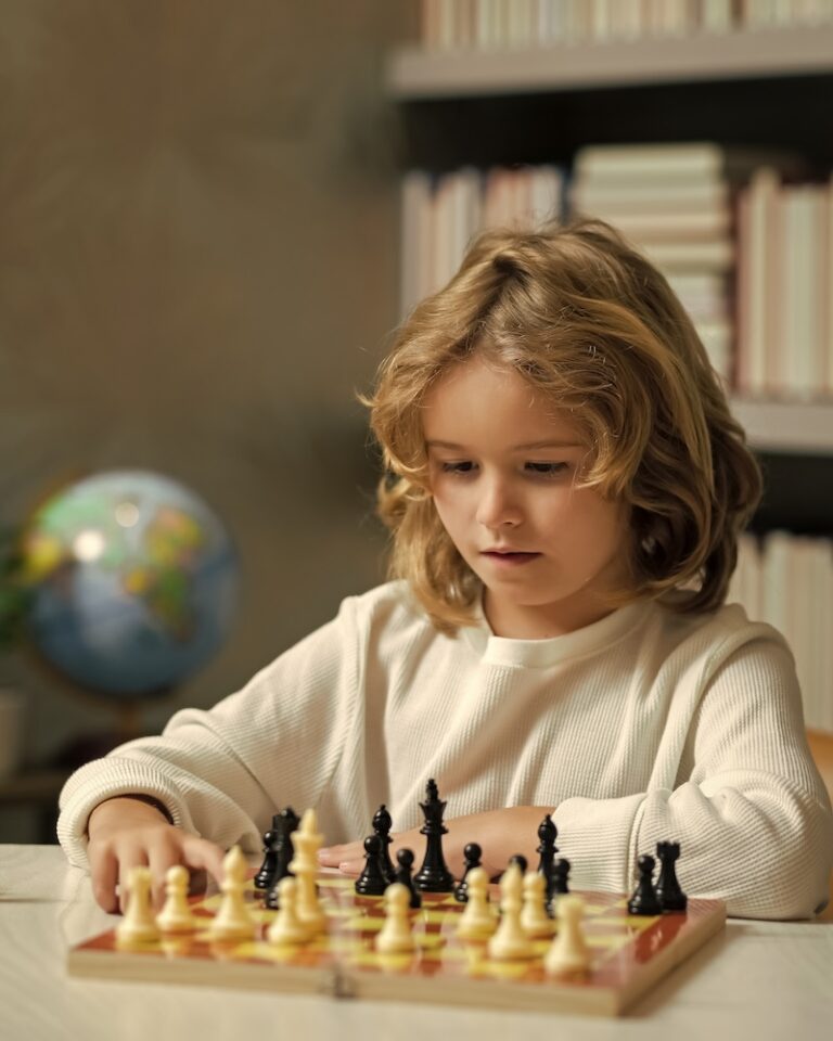 A small child playing chess, checkmate.