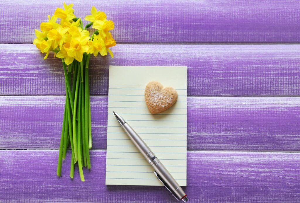 Daffodils, notebook, pen