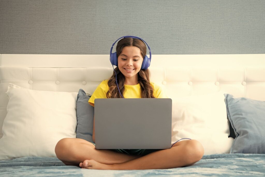 Girl with headphones and a laptop
