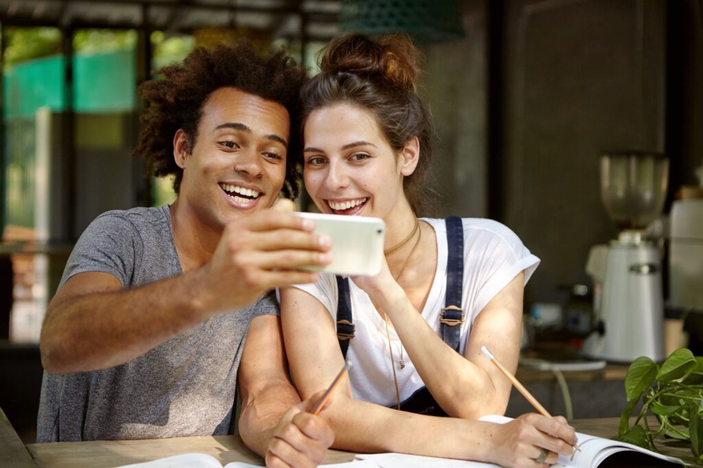 A girl and a man are taking a selfie.