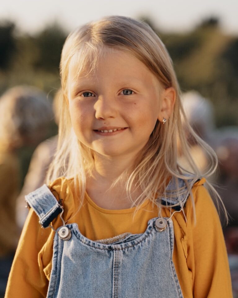 Medium shot of a smiling girl outdoors