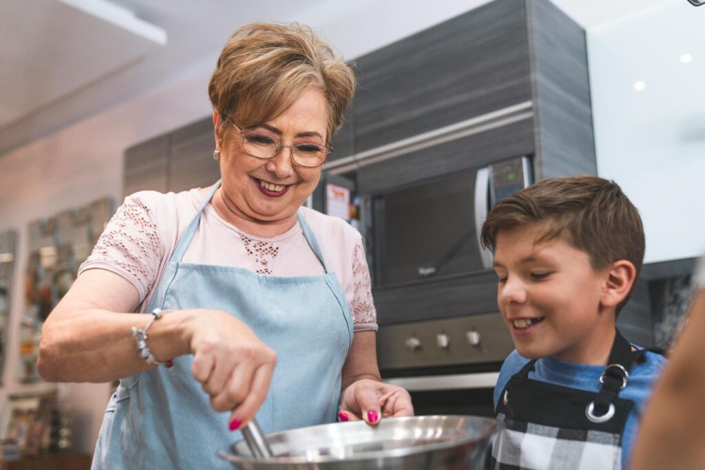 Grandmother and grandson are cooking in the kitchen