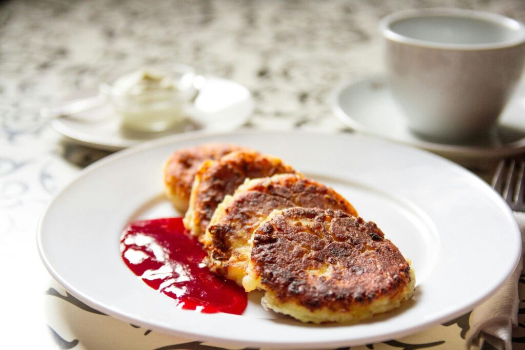 Syrniki on a plate and jam