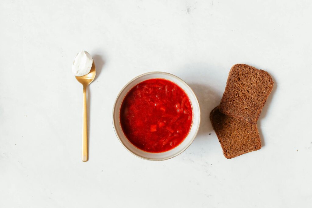 Borscht, a spoon of sour cream, bread