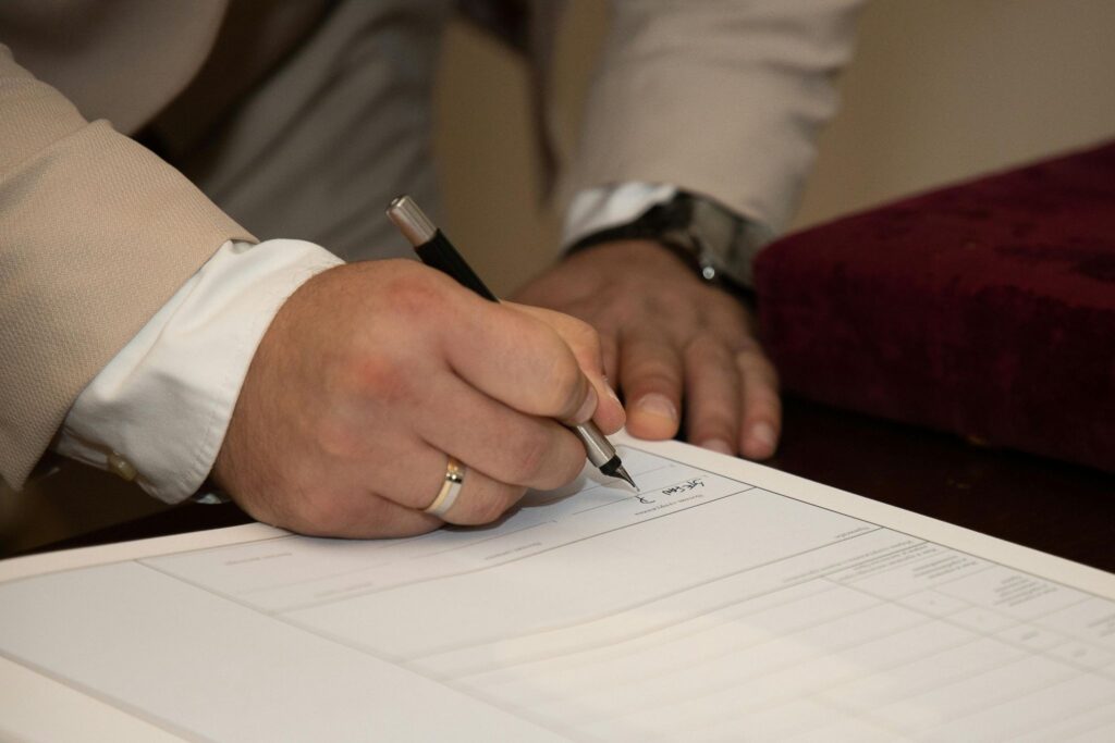 Men's hands signing a document
