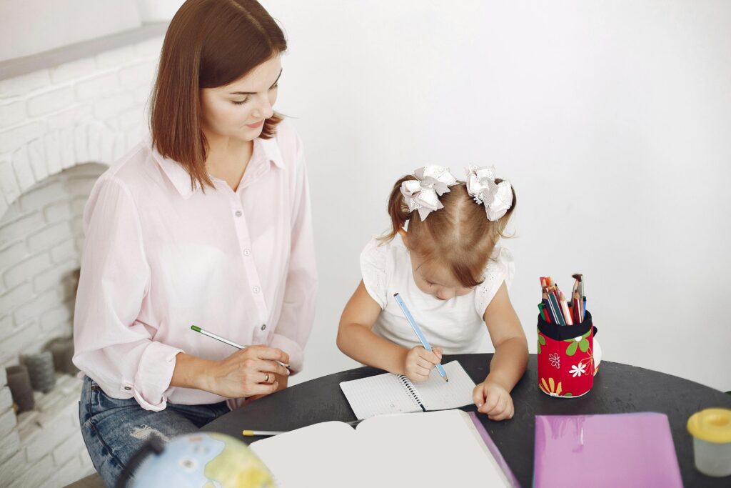 Mom and daughter are working at the table