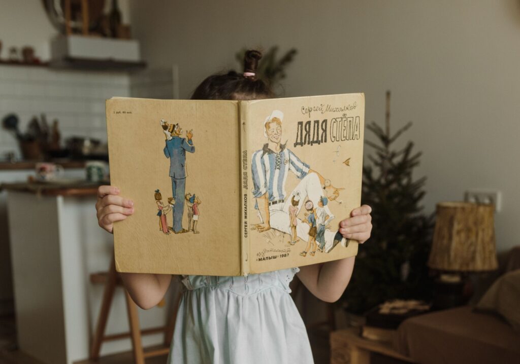 a Russian child reading a Russian book