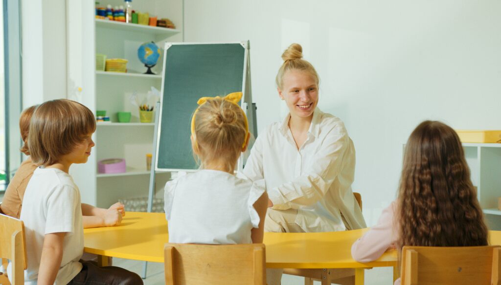 A teacher and four children in a classroom