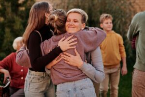 Family members embracing at a reunion, warm and candid
