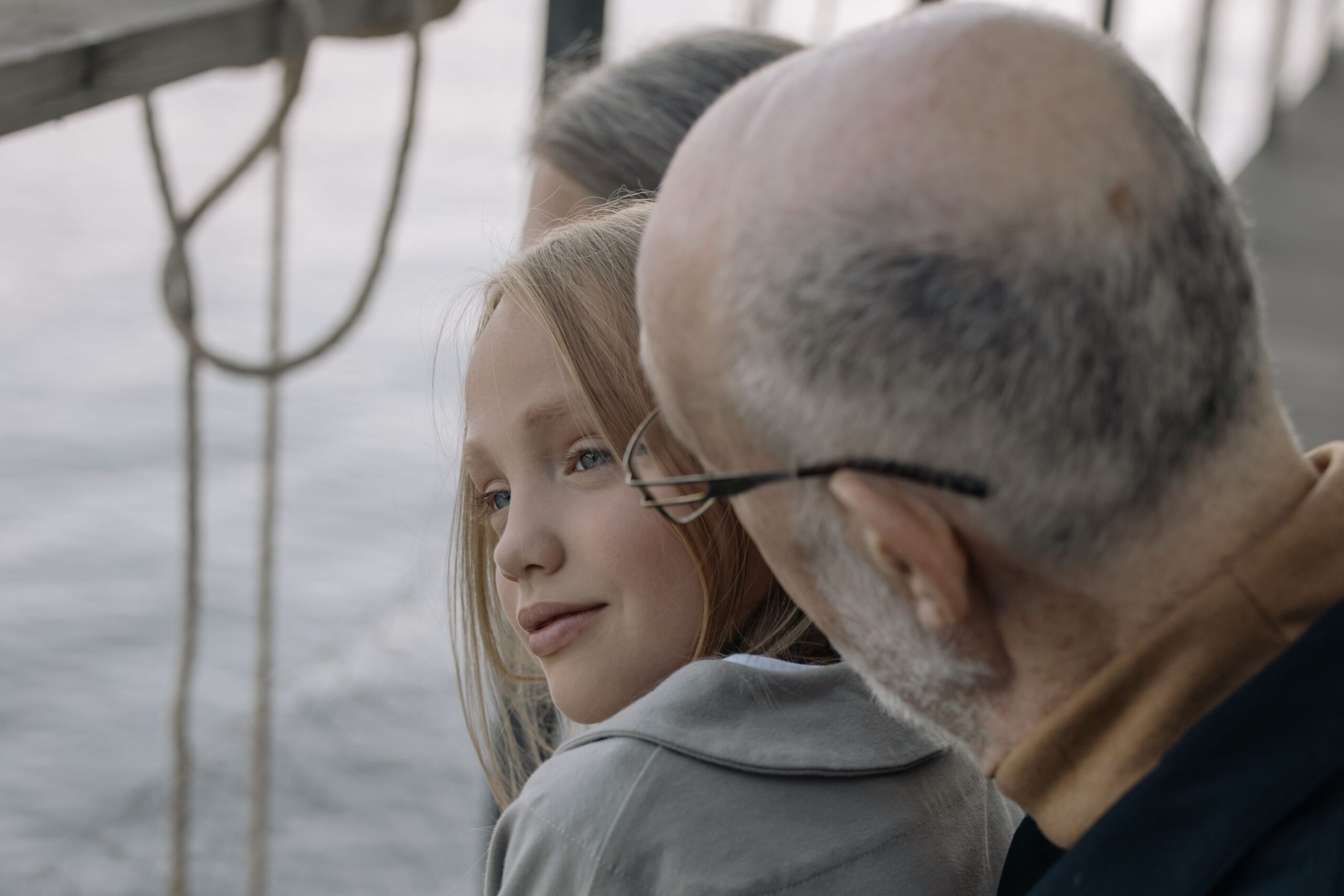 A granddad is speaking to his granddaughter
