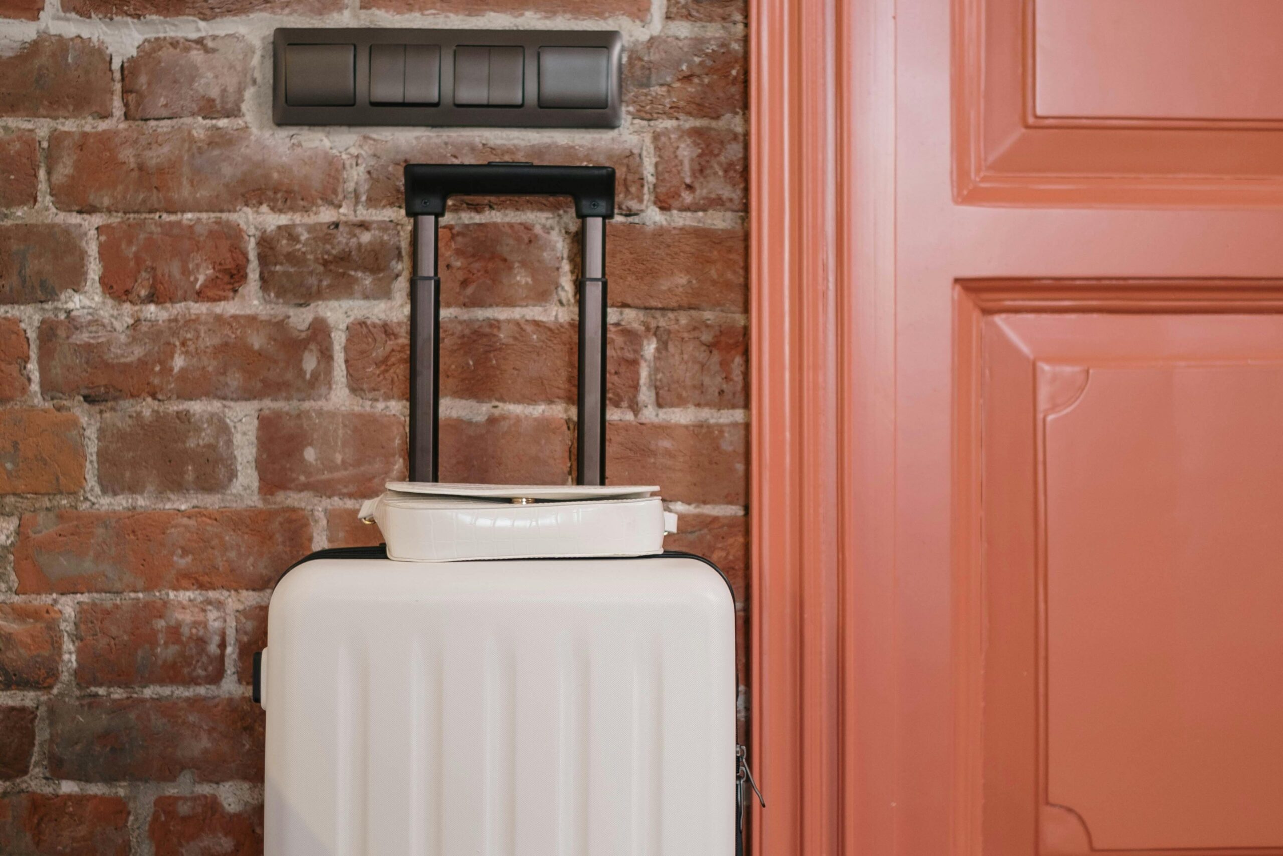 A door with a suitcase standing nearby