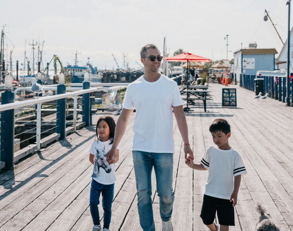 A dad is enjoying outdoor life with his children.