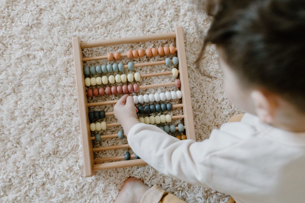 a child playing with an abacus