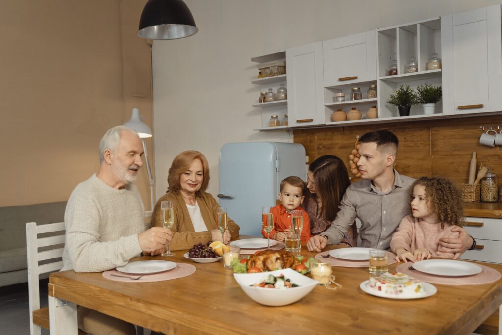 A family is celebrating while gathered around a kitchen table