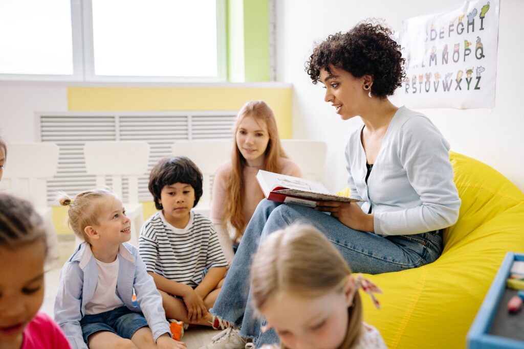 A teacher is explaining a book to children