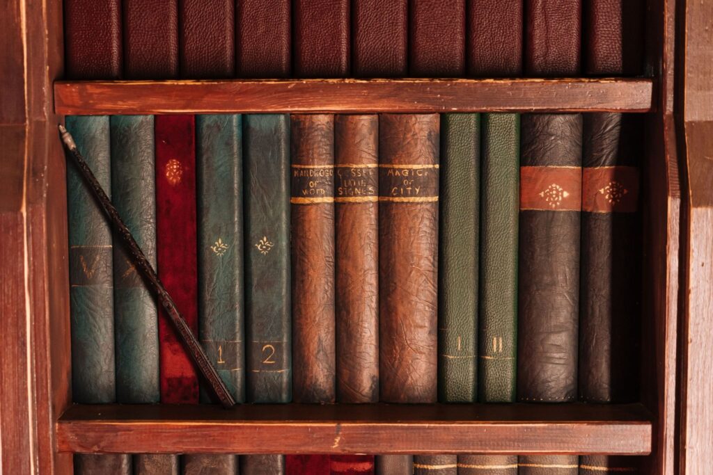 Antique leather-bound books on a wooden shelf