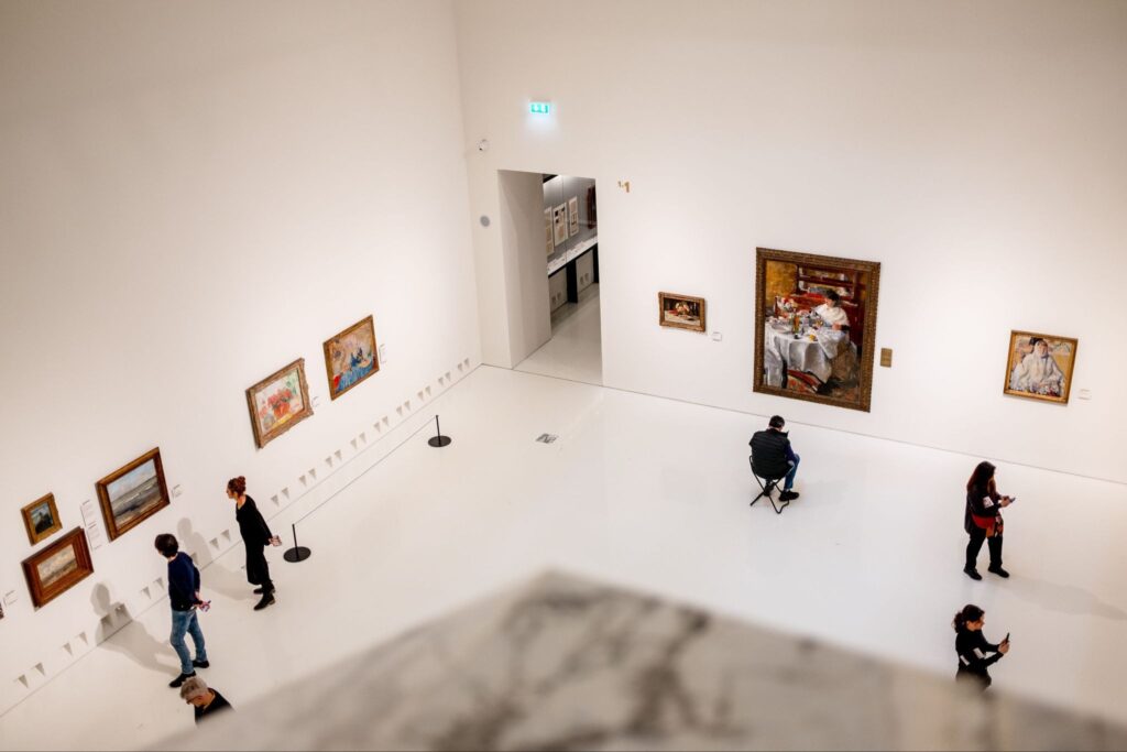 Visitors in a bright hall of an art museum