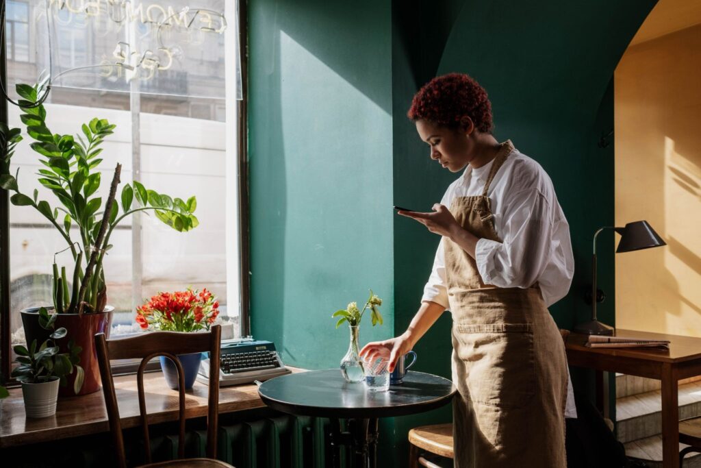 Warm cafe interior, a waiter setting the table