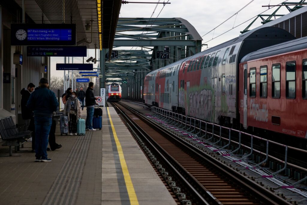 Passengers on the platform, the train is ready to depart.