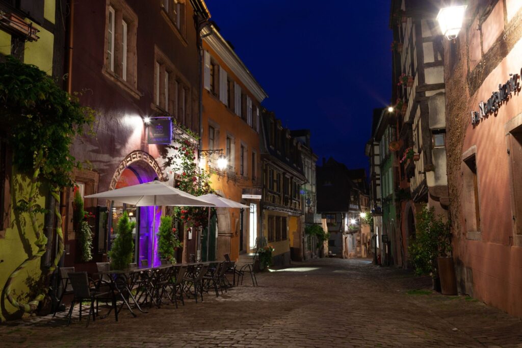 Cozy evening street with warm cafe light