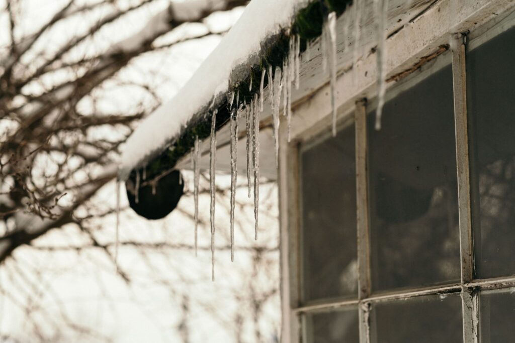 Icicles hanging from a gutter in the sun