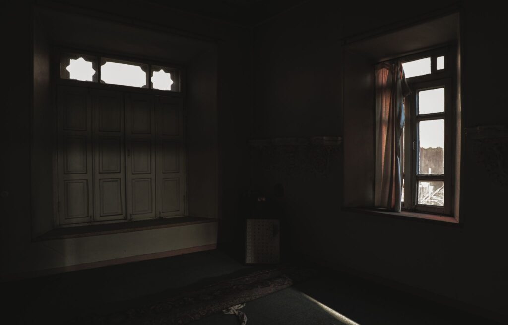 Light from the window in the dark room of an old house