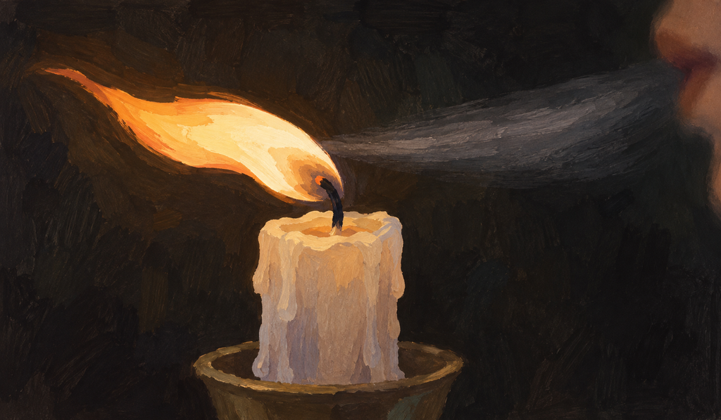 A candle flame bent sideways by a short breath of air