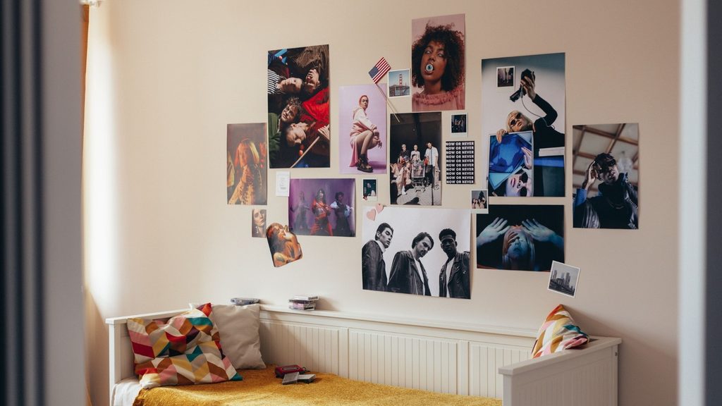 A feelings chart on a child's bedroom wall with cards scattered below it