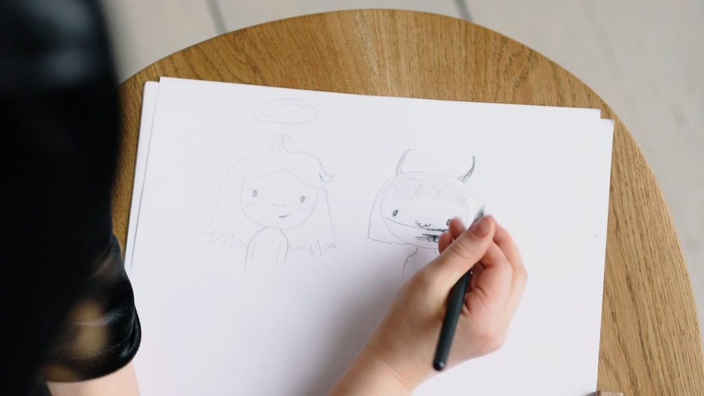 A half-erased drawing on a sheet of paper with a pencil set down beside it